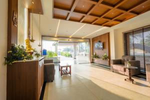 a living room with a couch and a table at Casa Marina Beachfront Resort in Padubidri