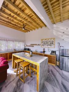 a kitchen with a large wooden table and chairs at Wa'a House Batukaras in Batukaras