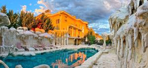 a resort with a pool in front of a building at Бутиков хотел History in Haskovo