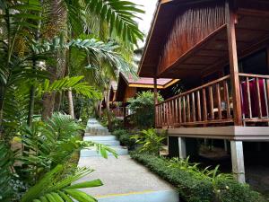 a pathway leading to a house with a balcony at PawPaw Resort in Lamai +82 photos