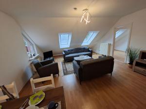 a living room with two couches and a table at Ferienwohnung Roessing 25194 in Bunde