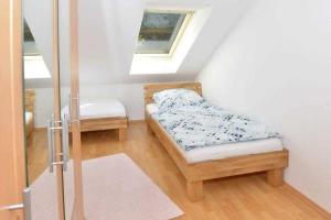 a small room with a bed and a window at Ferienwohnung Roessing 25194 in Bunde +7 photos