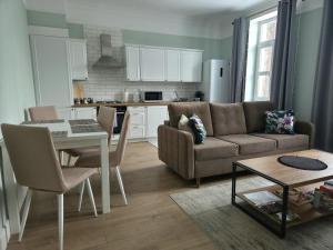a living room with a couch and a table at Apartamenty u Antka in Nowe Miasto Lubawskie