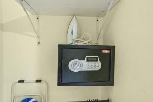 a picture of a camera on a wall with a surfboard at Cheap Hotel Room in Sosua Center in Sosúa +7 photos