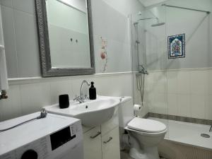 a bathroom with a sink and a toilet and a shower at Apartamenty u Antka in Nowe Miasto Lubawskie +11 photos
