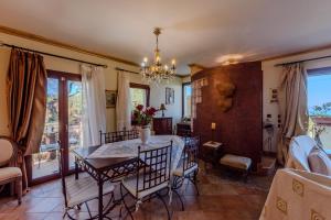 a dining room with a table and chairs at Aerino House in Dassia