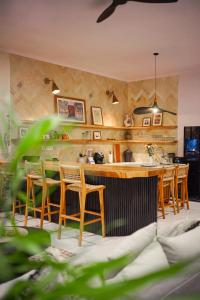 a kitchen with wooden chairs and a kitchen island at Homey Villa in Canggu