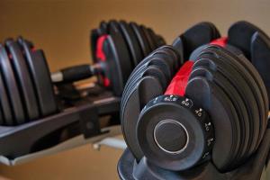 a row of dumbbells on a rack in a gym at Homey Villa in Canggu