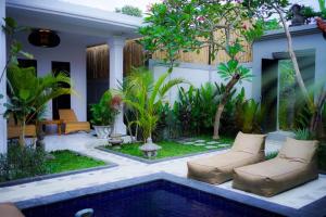 a backyard with a swimming pool and a house at Homey Villa in Canggu
