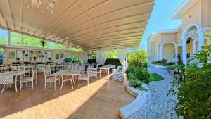 an outdoor dining area with tables and chairs at Бутиков хотел History in Haskovo