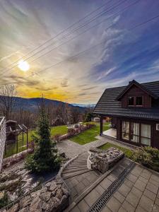 a house with a patio with a christmas tree on it at Willa Żar in Bialskie