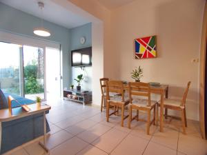 a living room with a dining room table and chairs at Peris #2 - Souda in Souda