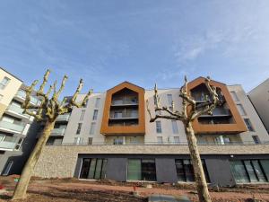 two trees in front of a building at DOMITYS - Les Cristaux in Le Creusot