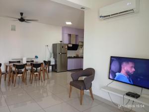 a living room with a large flat screen tv on a wall at Seberang Jaya Family Pool Homestay Near Hospital 3 Bedroom Aircond 2 Bathroom & Family Room Aircond in Perai