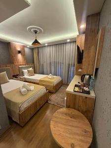 a hotel room with two beds and a table at Yellow Bull Istanbul hotel in Istanbul +36 photos