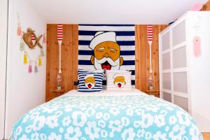 a bedroom with a bed with a chef headboard at Beach House in Lège-Cap-Ferret