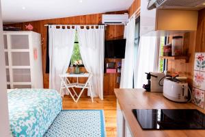 a kitchen with a bed and a table in a room at Beach House in Lège-Cap-Ferret