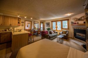 a kitchen and living room with a couch and a fireplace at Iron Horse Building D Unit 4104 in Winter Park +43 photos