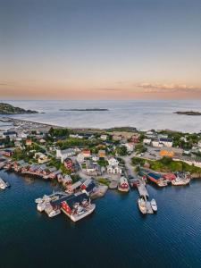 an aerial view of a harbor with boats in the water at Maybua by May's in Reine