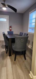 a dining room with a black table and chairs at 3 Bedroom home near DC in Oxon Hill