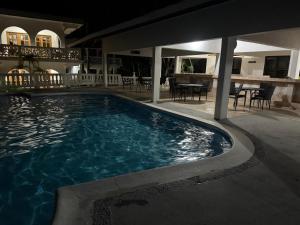 a swimming pool in the middle of a house at Dvilla Resort in Negril