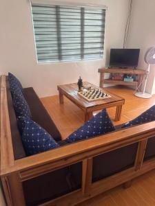 a living room with a chess board and a table at El Nido Homestay in El Nido