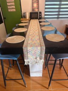 a long table with chairs in a room at El Nido Homestay in El Nido +6 photos