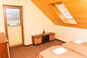 a bedroom with two beds and a window at Urocze Wysowa in Wysowa-Zdrój