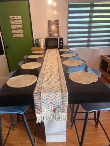 a long table with chairs in a room at El Nido Homestay in El Nido