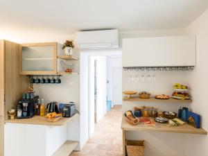 a kitchen with a counter with food on it at Lambo Cellini - Bed & Breakfast in Valdobbiadene
