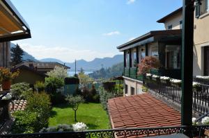 a balcony of a house with a view of a yard at Albergo Della Torre in Cernobbio