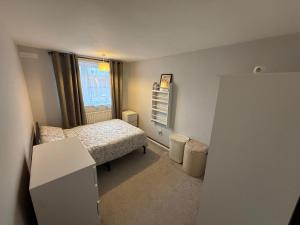 a small bedroom with a bed and a window at Birch House in London
