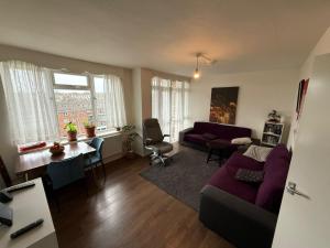 a living room with a couch and a table at Birch House in London
