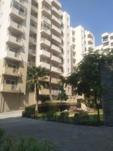 a large apartment building with trees in front of it at Supremo Home Stays in Agra