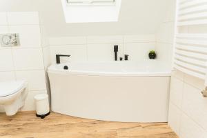 a white bathroom with a sink and a toilet at Urocze Wysowa in Wysowa-Zdrój +45 photos