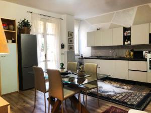 a kitchen with a table and chairs and a refrigerator at B & B Da Giusy in Corte Franca