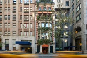 a city street with tall buildings and a building at Loews Regency New York Hotel in New York