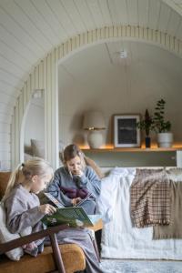 two girls sitting on a couch reading books at Iglupark in Tallinn