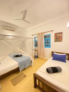 a bedroom with two beds and a ceiling at Coco Bliss - Ahangama in Ahangama +67 photos
