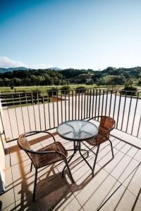 a patio with a table and two chairs on a balcony at BRIC Wine & Relax in Vogrsko
