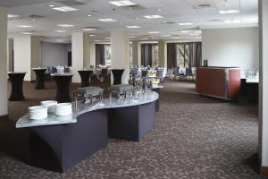 a restaurant with tables and chairs in a room at Courtyard Grand Rapids Downtown in Grand Rapids