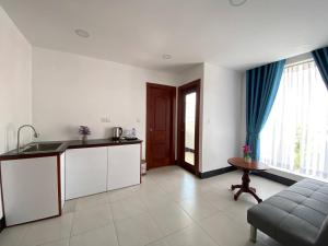 a kitchen and living room with a sink and a couch at HomeStore Apartment in Siem Reap