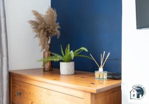 a wooden dresser with two potted plants on it at Reading 3BR Contractor Accommodation, Sleeps 6, Near Oracle, Free Parking in Reading