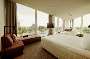 a bedroom with a large bed and large windows at Van der Valk Hotel Amsterdam Zuidas-Rai in Amsterdam +109 photos