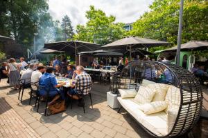 a group of people sitting at tables at an outdoor restaurant at Let's Meet Elewijt in Elewijt