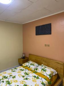 a bedroom with a bed and a picture on the wall at Nid douillet kribi in Kribi
