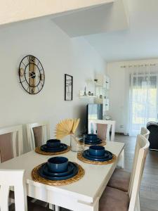 a dining room with a table with blue plates on it at Valamar Deluxe Beachfront Villa in Draç +5 photos