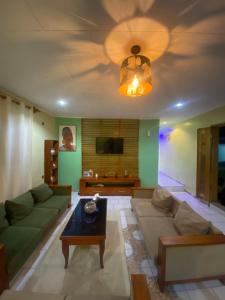 a living room with a couch and a table at Nid douillet kribi in Kribi