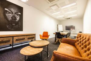 a living room with a couch and chairs and a table at Let's Meet Elewijt in Elewijt