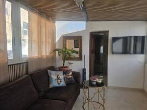 a living room with a couch and a flat screen tv at Appartamento Dancardi in Quartu SantʼElena